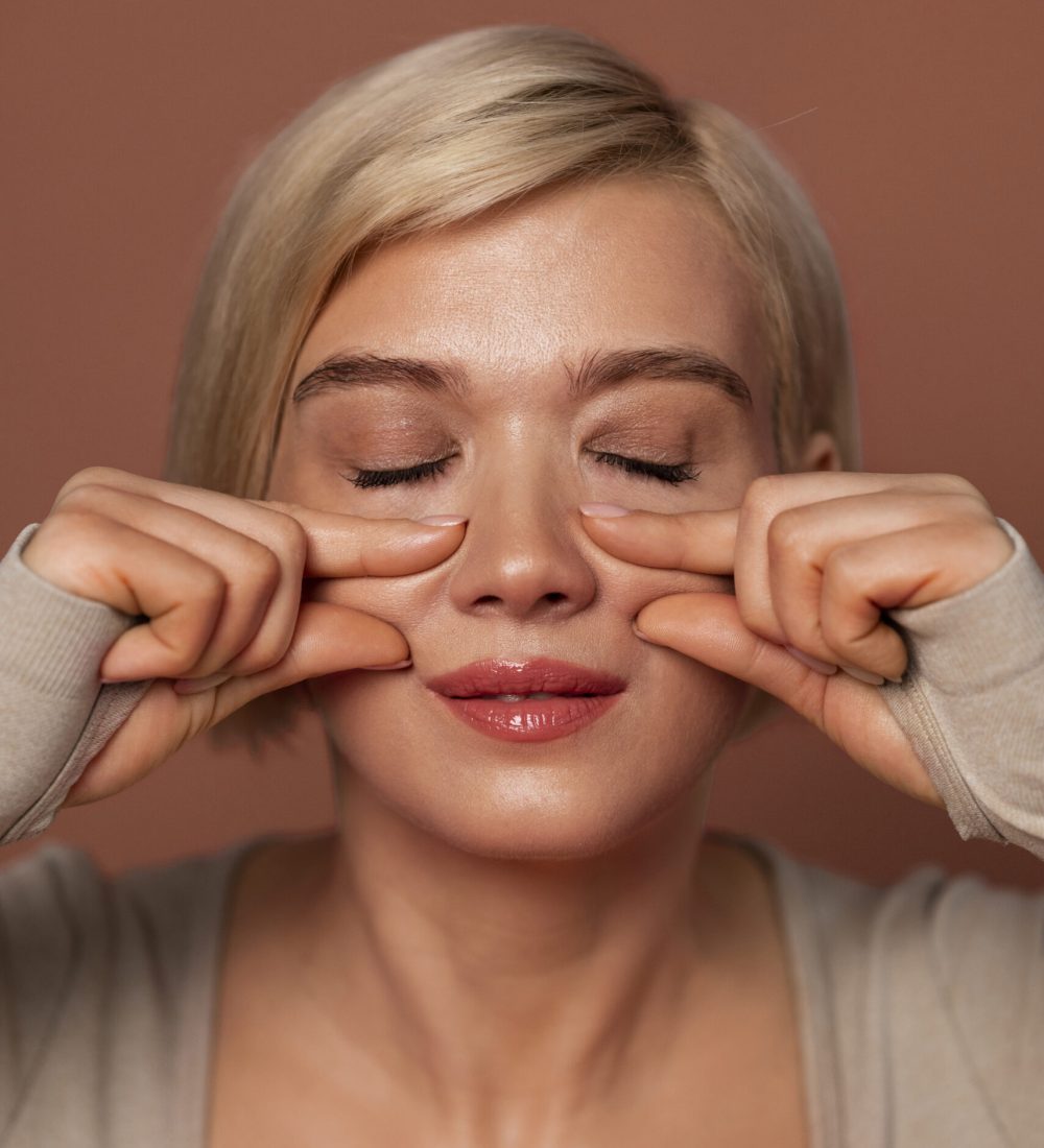 front-view-woman-practicing-facial-yoga front-view-woman-practicing-facial-yoga